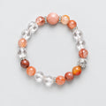 Beaded bracelet with pink and clear beads on a black background