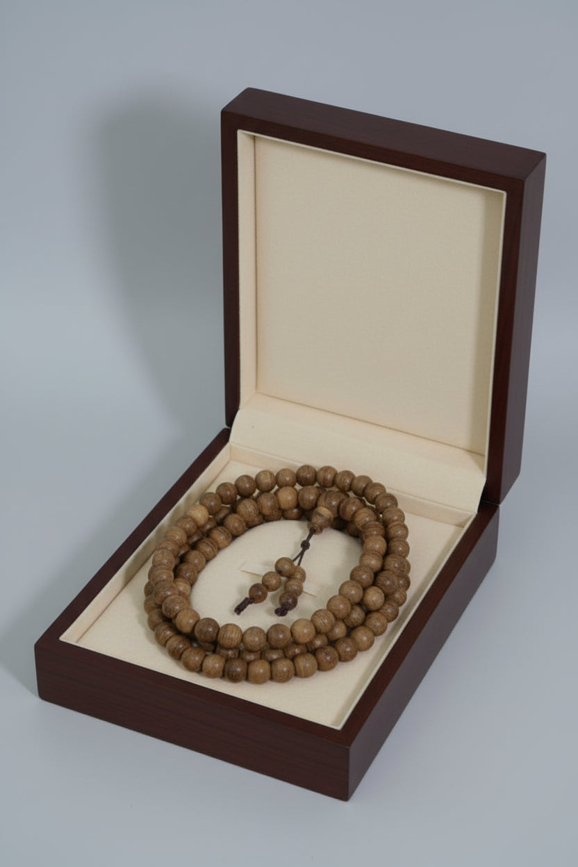 Wooden beaded necklace on a mannequin bust against a black background