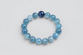 Blue beaded bracelet on a white textured background
